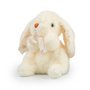 Professional studio product shot of an adorable soft beige stuffed rabbit. Vintage plush hare toy with floral patterned ribbon bow tie for baby nursery and online store catalog.