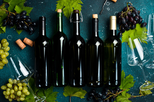 Set of wine bottles. Aged wine in bottles. On a gray stone background. Top view.
