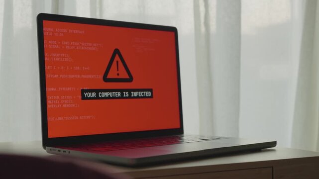 Computer screen in office or home glitches and displays hacker group message. Remote access of personal laptop infected by malware or virus by spy agency or hacker team. Warning alert on monitor