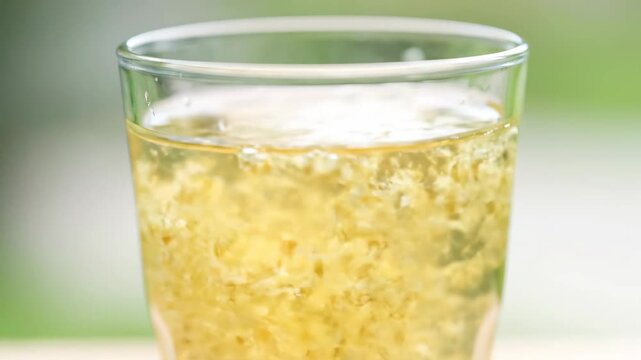 Romantic elderflower juice pouring into glass