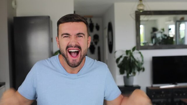 Happy man expressing absolute shock and joy after hearing amazing news