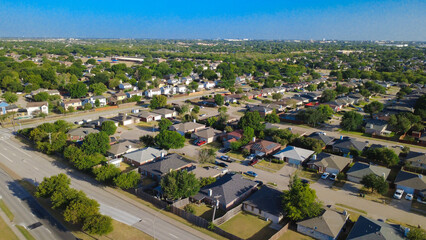 Fototapeta premium Subdivision avenues weave through manicured tracts south of East Sublett Road corridor. Shingled single family homes border wide paved street networks, vibrant tree lines, Arlington, Texas