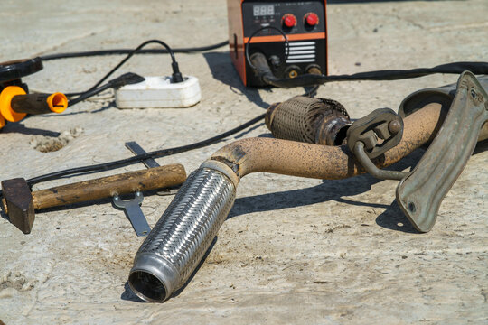 A new corrugated exhaust pipe welded in place of the old worn one.