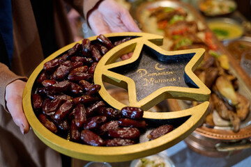 Fototapeta premium Ramadan Dates Platter With Crescent Star Tray and Ramadan Mubarak Greeting For Iftar Celebration