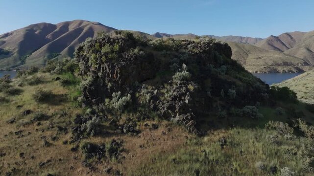 Aerial view of the rocky hills and landscape surrounding Lucky Peak Lake in Ada County, Idaho, United States.