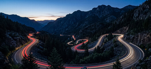 Winding mountain road with car light trails at dusk ©  rdmmokx