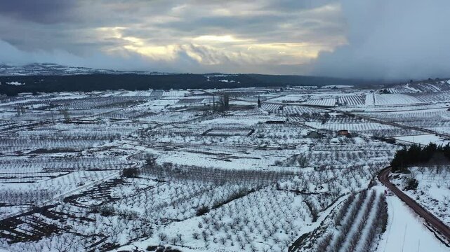 Aerial view of snow covered fields in the Golan Heights near Buq'ata, Israel.
