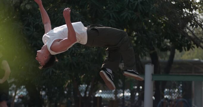 Experience the athleticism of parkour in 1000fps slow motion with a dynamic time ramp. Watch as the skill athlete executes a precise backflip with a twist, highlighting incredible body control