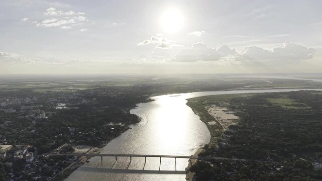 Aerial drone footage of the Gorai River in Kushtia, showing a long bridge, a broad waterway, green riverside areas, sandy banks, and scattered settlements.