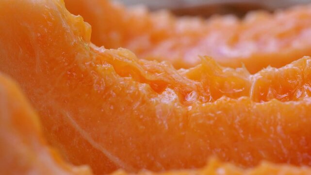 fresh cantaloupe melon slices with vibrant orange flesh and green rind