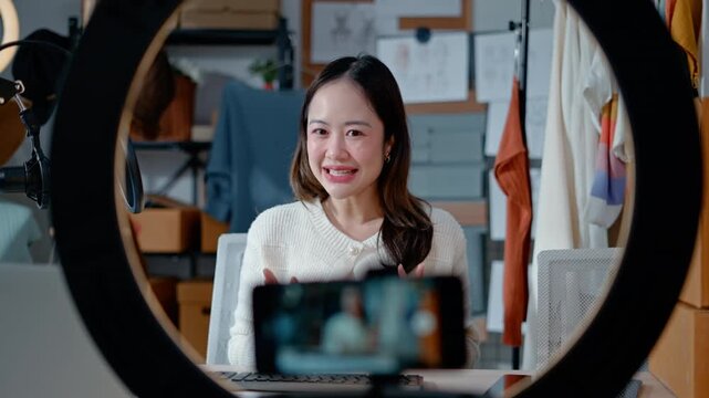 Asian woman Gen Z live streaming fashion clothing sales and looking at camera,social commerce influencer web broadcasting,e-business,e-commerce on entrepreneur,order confident,new business for gen Z
