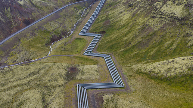 Aerial view of Hellisheidi Geothermal Power Plant with zigzagging steam pipelines running across the mossy volcanic landscape in Olfus, Sveitarfelagid Olfus, Iceland.