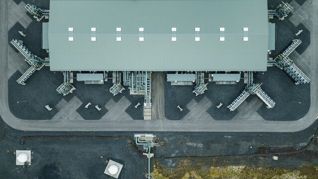 Aerial view of the Direct Air Capture and Storage Plant featuring industrial piping and large facility structures on gravel ground in Olfus, Sveitarfelagid Olfus, Iceland.