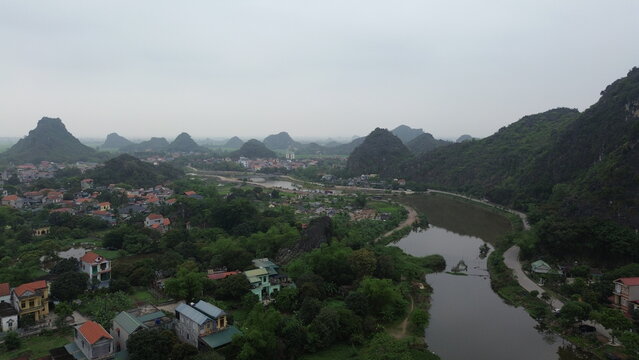 Aerial view of ancient capital Hoa Lu historic temples and stone gate nestled in limestone karsts, Ninh Binh, Vietnam