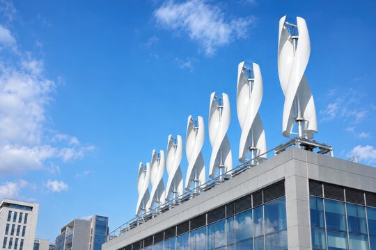 Vertical axis wind turbines spinning on city rooftop