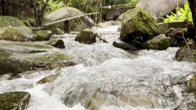 Beautiful mountain stream after a rainy day. Slow tilt up reveal. Fa sam rock, Hong Kong.