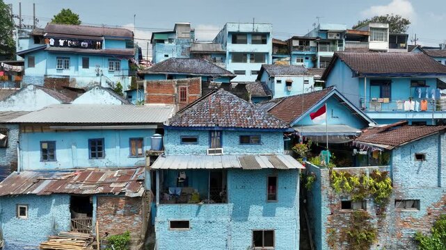 Aerial Drone Tilt Up Over Kampung Biru Arema Blue Village Revealing Colorful Neighborhood, Malang Indonesia