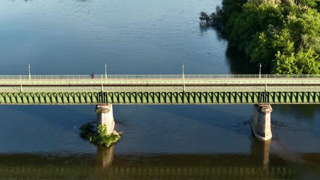 The Pont Canal in Briare, France, showing the iconic green metal canal bridge crossing a wide river, aerial view.