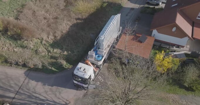 Truck Mounted Crane Working Between Houses Seen From Above