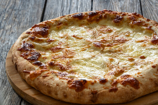 Pizza Bianca white pizza with oregano on wooden table

