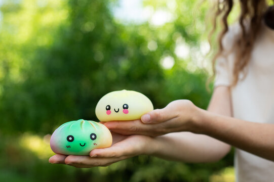 Small kawaii dumpling squishy toy resting on an open palm.