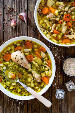 Krupnik - polish barley soup with chicken meat on wooden table
