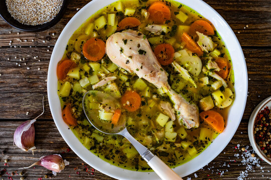 Krupnik - polish barley soup with chicken meat on wooden table. top view
