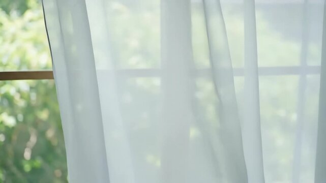 Sheer white curtains gently swaying, diffusing pale daylight across a serene window interior, creating a tranquil home ambiance for relaxation, wellness blogs