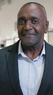 Portrait African American mature business man smiling happy looking at camera posing in store clothes shop in shopping mall cheerful senior businessman middle-aged male positive smile buying clothes