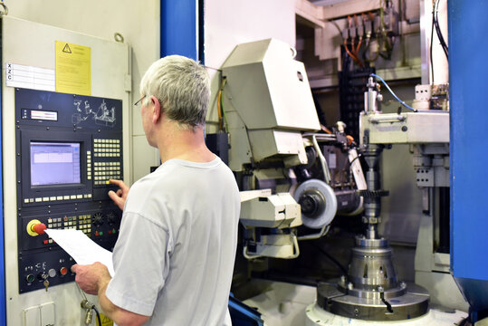 cnc machine in modern industrial mechanical engineering - workers at the workplace