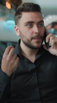 Angry Caucasian businessman talking mobile phone arguing in business center irritated annoyed man male guy employer argue talk smartphone communication problem conflict quarrel chat in shopping mall