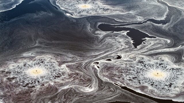 Aerial view of Georgia-Pacific Palatka Operations featuring circular aerators creating intricate foam patterns on industrial wastewater treatment ponds in Palatka, Florida, United States.