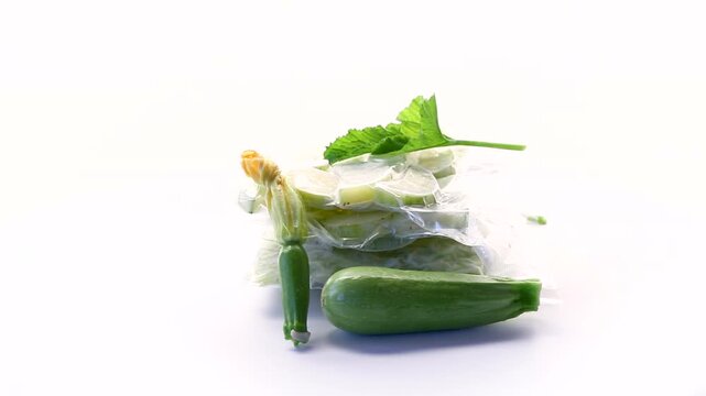 Vacuum packed zucchini slices with fresh vegetable and flower