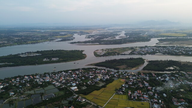 High altitude aerial view of Hoi An city and winding river tributaries in Thu Bon river delta, Vietnam
