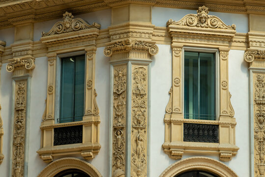 Architectural Detail with Carvings on Windows of Historic Building in Milan City, Italy. Sculptures inside Galleria Vittorio Emanuele. Italian architecture.