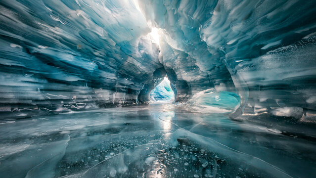 Stunning panoramic view of a magical blue ice cave with glowing light filtering through the frozen arches
