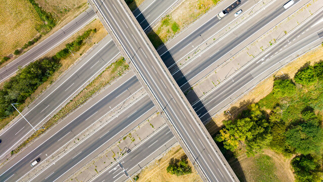 Highway junction with intersecting roads and vehicles during daytime