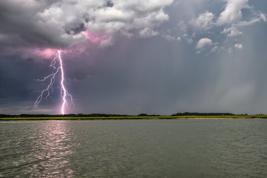 Lightning strikes over water near Beaufort SC during a stormy day