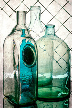 Still life with different transparent glass bottles