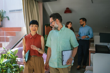 Business colleagues collaborating and discussing in modern office environment