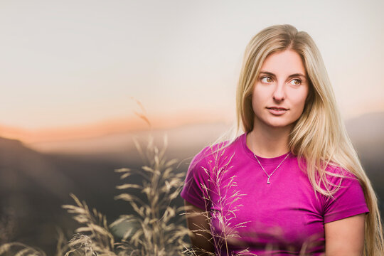 Young woman enjoying mountain view at sunset