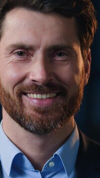 Close up portrait Caucasian middle-aged business man smiling happy looking at camera at dark night evening office headshot bearded male businessman executive professional employer look smile cheerful