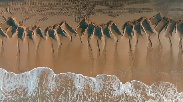 Aerial view of tidal sand patterns and water channels along the shoreline at Ellis Beach, Cairns, Queensland, Australia.