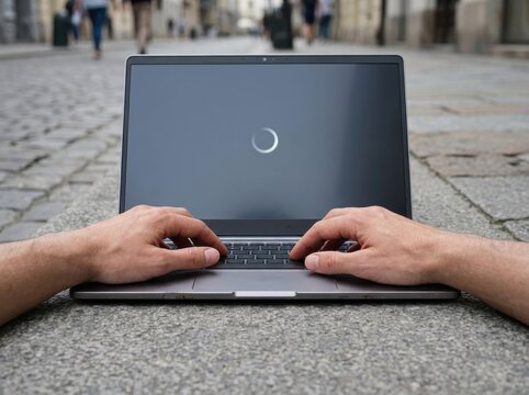 Laptop Loading Screen on Outdoor Pavement
