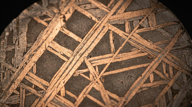 Iron meteorite cross section shows intricate patterns and textures, revealing its unique