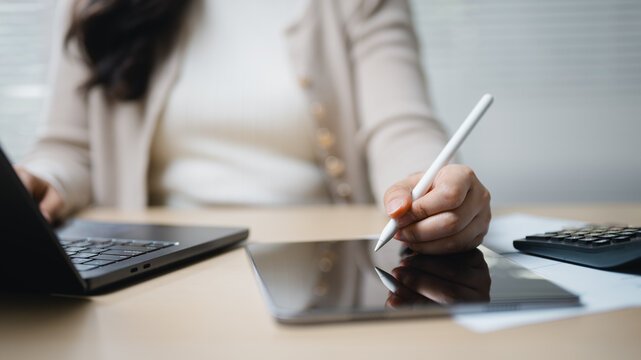using tablet analysis with data audit; a person using a tablet for analysis. using guides buyer choices, tablet frames the scene, and analysis adds useful meaning. In a clear visual scene.