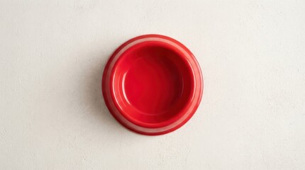 Fototapeta premium Empty red pet food bowl on white textured surface, top view