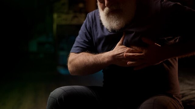 Unhappy bearded man experiences sharp chest pain at home, cardiovascular risk