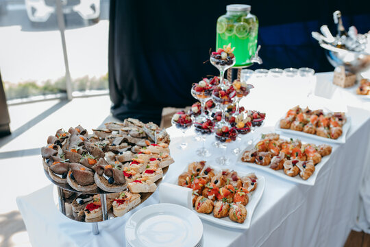 Food and drinks on corporate party table.
