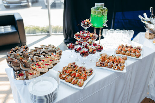 Food and drinks on corporate party table.